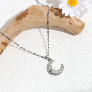 Elegant silver crescent moon necklace with sparkling rhinestones and star charm for women.