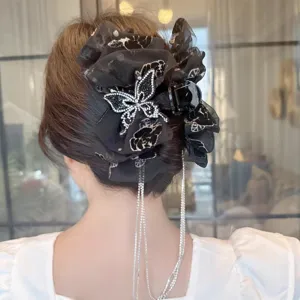 Elegant black mesh hair claw with sparkling rhinestone butterfly and beautiful hanging tassel detail.
