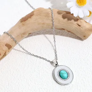 Stunning turquoise pendant necklace featuring sparkling rhinestones on a delicate silver chain.