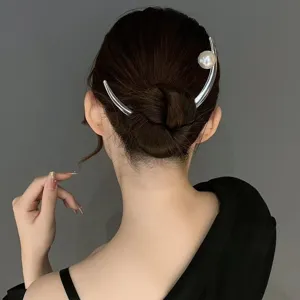 Silver pearl U-shaped hairpin detail shot, elegant bridal hair bun accessory for women.