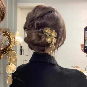 Crystal flower hair pin detail shot showing elegant hair bun styling with sparkling rhinestone design.