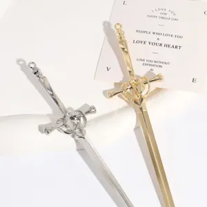 Metal sword hair stick detail close-up, vintage silver and gold hair accessory design.