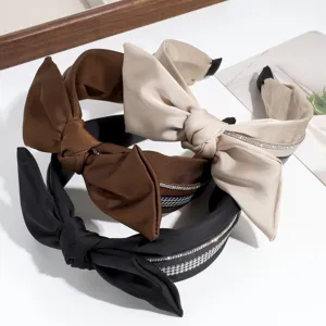 Fashion wide satin bow headband with classic houndstooth and sparkling rhinestones.