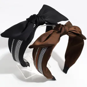 Wide satin bow headband featuring classic houndstooth pattern and sparkling rhinestone details.
