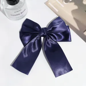 Dark blue satin bow hair clip with long ribbons, an elegant vintage hair barrette.