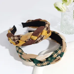 Detail view of stylish velvet braided headband with contrast color design, elegant hair accessory.