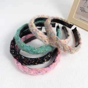 Detailed view of fashionable simple elegant braided fabric hair band winter versatile fuzzy hoop.