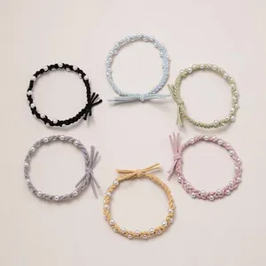 Detailed view of Korean style braided hair ropes decorated with elegant faux pearls, multi-color.
