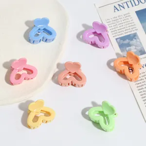 Close-up detail shot of colorful candy heart mini hair claws for sweet daily hairstyles.