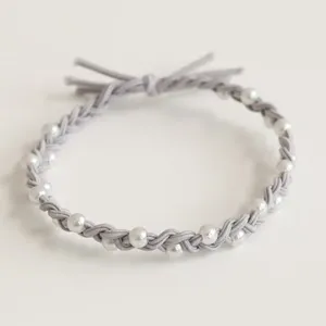 Detailed close-up of the grey braided hair rope adorned with elegant white faux pearls for women.