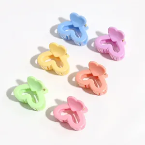 Pastel heart hair claw clip detail shot, cute colorful mini hair accessories for styling bangs.