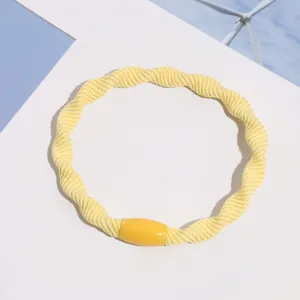 Yellow braided hair tie with bead detail, perfect for daily casual hairstyles and elegant styling.