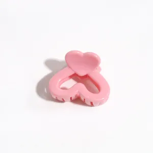 Pink heart hair claw clip detail shot, sweet candy color cute small bang clip accessory.