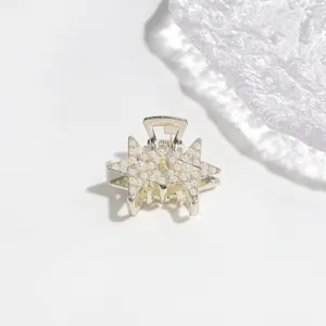 Detailed close-up shot of silver-tone metal hair claw clip adorned with faux pearls.