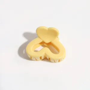 Close-up detail of the cute yellow heart hair claw clip, perfect for sweet styling daily.
