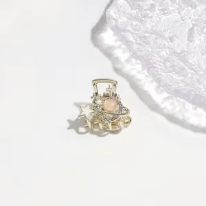 Close-up detail of the elegant alloy hair claw clip with rhinestones and star charm.