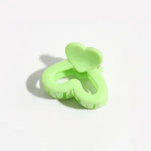 Green heart hair claw clip detail close up, sweet candy style cute mini hair accessory.