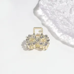 Gold tone rhinestone hair claw clip detail view, elegant mini metal hair accessory for styling.