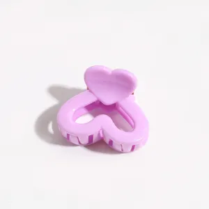 Purple heart hair claw clip detail view showing cute design and sturdy teeth for styling.