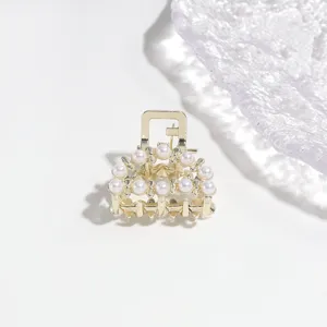 Close-up detail of pearl alloy hair claw clip, compact hair accessory for elegant styling.