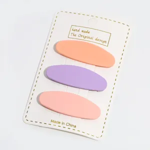 Detail view of pastel oval hair clips set, matte candy color hair accessories on card.