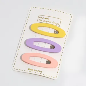 Detailed closeup view of candy color oval hollow hair clips, charming three pieces set.