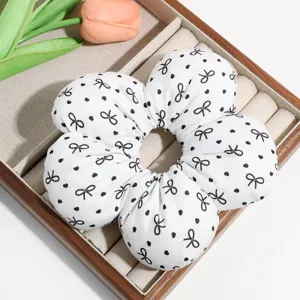 Sweet white floral hair scrunchie with cute black bows and polka dots for women daily wear.