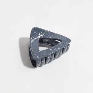Grey triangular hair claw clip with silver splatter pattern for women, stylish and secure.