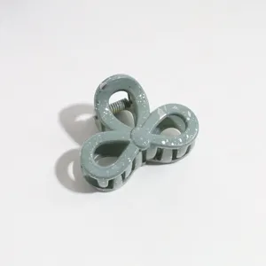 Green bow hair claw clip with silver speckles, elegant half-up styling accessory for daily wear.