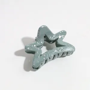 Detailed shot of grey green star hair claw clip with silver splatter design for daily styling.
