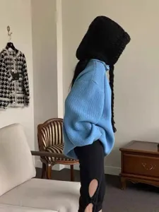 Cozy knitted balaclava hat with braided details in detail view, winter warm knitted headwear.