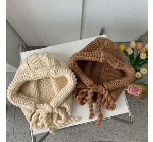 Women winter warm knitted balaclava hat with braided ties cozy solid color earflap beanie detail.