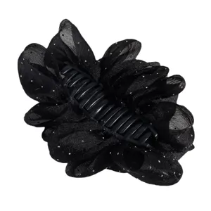 Detailed closeup of black mesh flower hair claw clip with sparkling rhinestones and teeth.