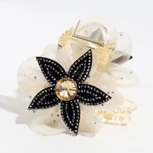Elegant mesh flower hair claw clip with sparkling rhinestones and clear plastic jaw.