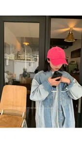 Retro pink baseball cap and patchwork denim jacket for women, casual streetwear style.