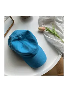 Blue washed cotton baseball cap with curved brim, soft top casual hat for women daily wear.