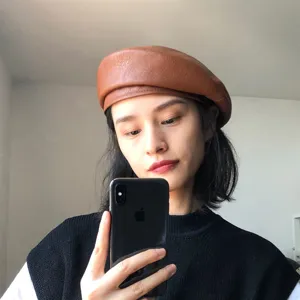 Brown PU leather beret detail showcasing retro vintage style, classic painter hat design for women.