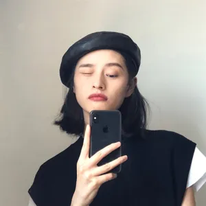 Classic black PU leather beret for women, vintage retro French style hat for daily wear.