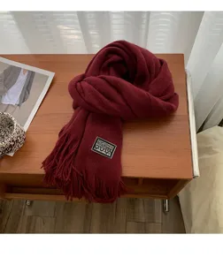 Red knitted winter scarf for women, cozy tassel design, warm casual long neck wrap.