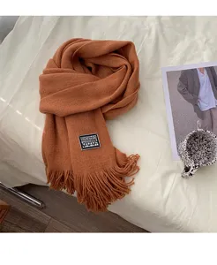 Cozy caramel winter knitted scarf with fringe detail, soft and warm accessory for daily wear.