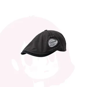 Detail shot of the dark grey newsboy cap featuring a side embroidered patch and contrast brim.