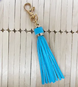 Blue PU leather tassel keychain detail showing gold metal lobster clasp and fringes for bags