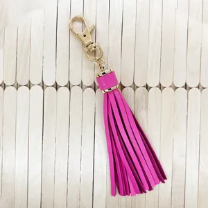 Pink PU leather tassel keychain detail with gold metal clasp for stylish bag accessories.