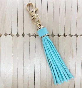 Light blue PU leather tassel keychain with gold metal clasp, stylish bag accessory.
