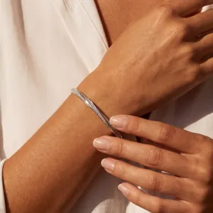 Close-up detail view of the elegant silver moissanite Mobius strip twist bangle bracelet.