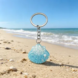 Close up detail of blue glitter shell keychain featuring lovely marine beach style design for bag.