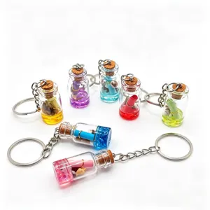 Mini glass wishing bottle keychain with colorful liquid, shells, and cute beach style charms.