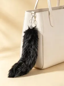 Fluffy black faux fur tail keychain and bag charm, soft cosplay accessory for handbags.