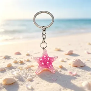 Pink glitter starfish keychain and bag charm detail view, sparkling resin sea star pendant