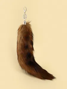 Detailed close-up shot of the fluffy faux fur tail keychain and bag pendant accessory.